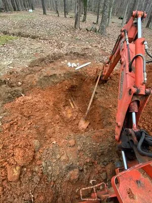 Rousseau's Excavating & Pipe Services Logo
